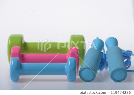 Barbells put in pattern near jump rope handles 119434226