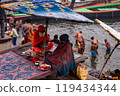 A Hindu Monk sitting on the bank of Ganges river in Varanasi Ghat during Kumbha mela. Benaras Utrar Pradesh India 01/05/2024 119434344