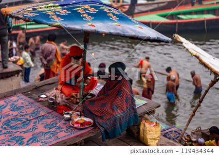 A Hindu Monk sitting on the bank of Ganges river in Varanasi Ghat during Kumbha mela. Benaras Utrar Pradesh India 01/05/2024 A Hindu Monk sitting on the bank of Ganges river in Varanasi Ghat during Kumbha mela. Benaras Utrar Pradesh India 01/05/2024 119434344