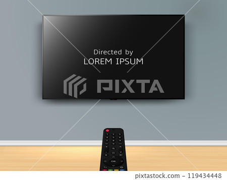 Watching online TV with movie credits on screen. Remote control is pointed at the TV on the wall. 119434448