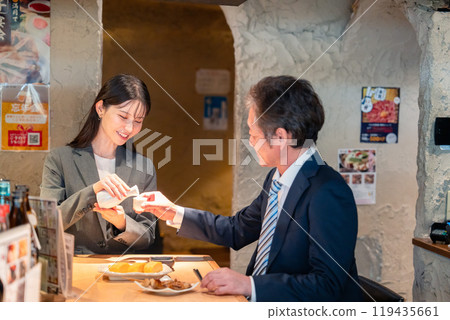 Senior businessman drinking with a woman Senior businessman drinking with a woman 119435661
