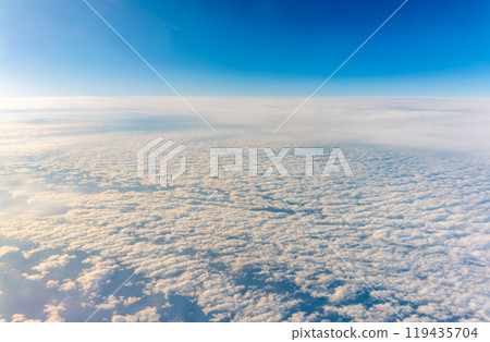 View from the airplane window at a beautiful cloudy sky and the airplane wing View from the airplane window at a beautiful cloudy sky and the airplane wing 119435704