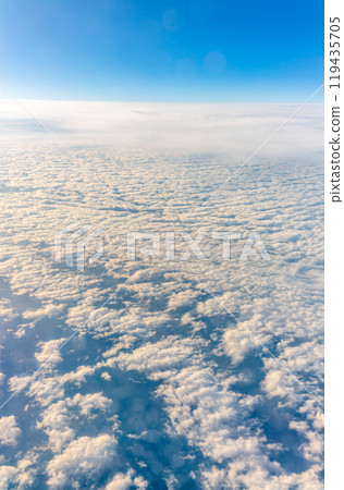 View from the airplane window at a beautiful cloudy sky and the airplane wing View from the airplane window at a beautiful cloudy sky and the airplane wing 119435705