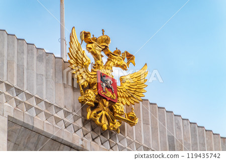 Double golden eagle. Coat of arms of Russia on the roof top of the Big Kremlin concert hall Double golden eagle. Coat of arms of Russia on the roof top of the Big Kremlin concert hall 119435742