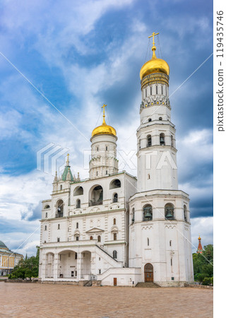 Ivan the Great Bell Tower, with Assumption Belfry on the right in Moscow Kremlin. Blue sky background with sunbeams 119435746