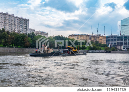 A barge with a tugboat floats along the Moscow River A barge with a tugboat floats along the Moscow River 119435789
