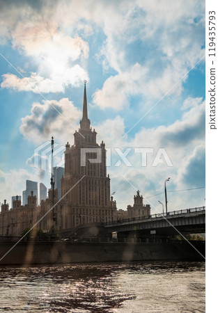 high-rise stalinist building near river at summer sunset in Moscow, Russia. Historic name is Hotel Ukraine. 119435793