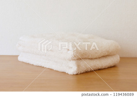Folded fluffy white towel 119436089