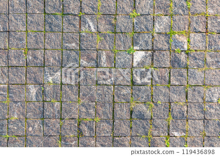 Stone block pavement in the rays of the setting sun. Texture Stone block pavement in the rays of the setting sun. Texture 119436898