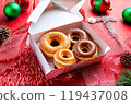 Donuts in a box Christmas. Delicious edible gift for Christmas: donut glazed on the holiday table 119437008