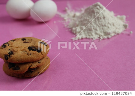 Background for a recipe for baking with chocolate. Cookies flour and eggs on a pink background with space for copyspace text 119437084