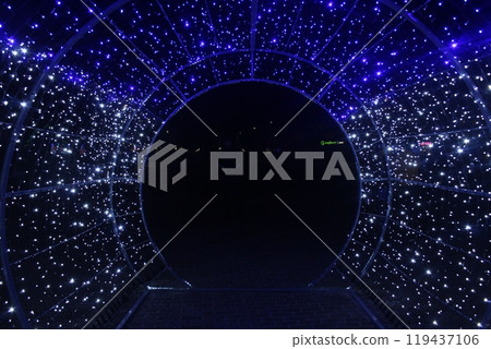 tunnel and illuminations of blue white on a black dark background. New Year's Eve Christmas. Photoona festive atmosphere. 119437106