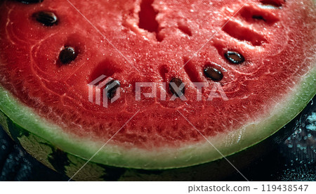 Vibrant watermelon slice beside whole fruit on a neutral backdrop 119438547