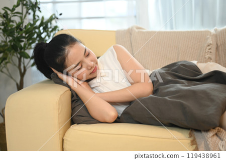 Young beautiful asian woman sleeping on couch at home Young beautiful asian woman sleeping on couch at home 119438961