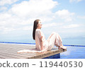 A smiling senior woman sitting on the wooden deck of Biwako Terrace 119440530