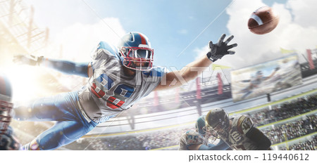 American football. Sportsman in action. Player catches the ball and flies in the air. Sports arena with fans. Bright sun. Front view 119440612