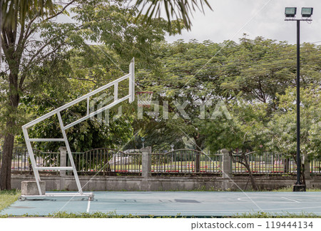 Basketball backboard with the hoop metal ring at basketball court in the park. Basketball backboard with the hoop metal ring at basketball court in the park. 119444134