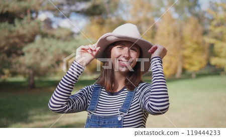 Portrait of a joyful middle-aged woman in a park Portrait of a joyful middle-aged woman in a park 119444233