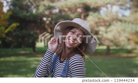 Portrait of a joyful middle-aged woman in a park Portrait of a joyful middle-aged woman in a park 119444234