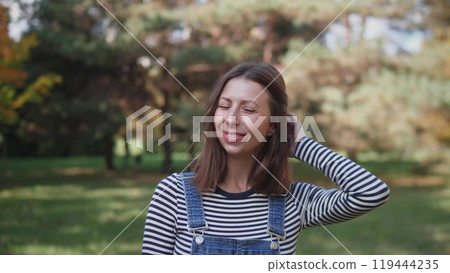 Portrait of a joyful middle-aged woman in a park Portrait of a joyful middle-aged woman in a park 119444235