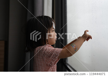 Girl looking out the window Girl looking out the window 119444871