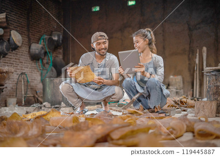 Creative Collaboration: Artisans Working Together in a Workshop Setting 119445887