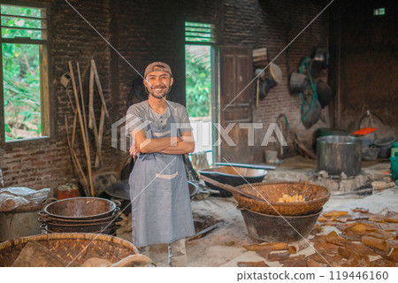 Smiling Baker in Rustic Kitchen with Traditional Tools and Ingredients 119446160