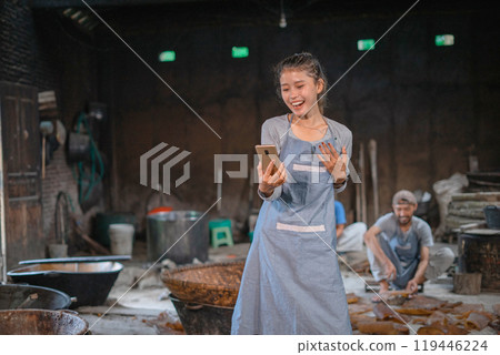 A Joyful Artisan in Their Workshop, Enthusiastically Celebrating WellDeserved Success A Joyful Artisan in Their Workshop, Enthusiastically Celebrating WellDeserved Success 119446224