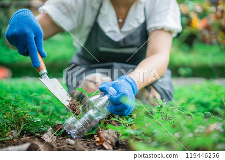 crop view woman hand gardening using recycled plastic bottle pot 119446256