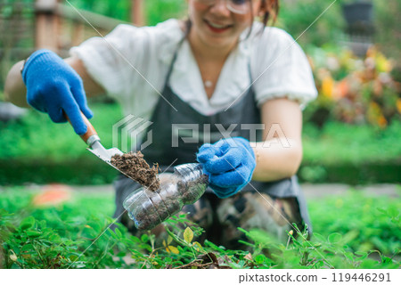 crop view woman hand fills recycled bottle with soil crop view woman hand fills recycled bottle with soil 119446291