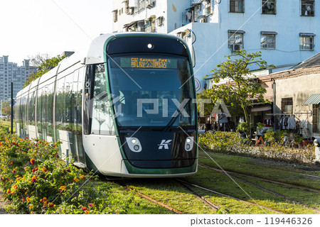 The circular light rail train drives past Pier-2 Art Center in Kaohsiung, Taiwan. The circular light rail train drives past Pier-2 Art Center in Kaohsiung, Taiwan. 119446326