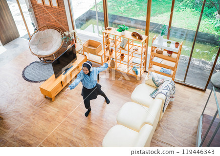 A Joyful Moment in a Bright and Modern Living Space Filled with Happiness A Joyful Moment in a Bright and Modern Living Space Filled with Happiness 119446343