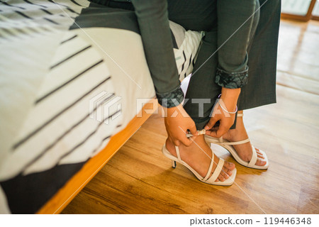 close up of a female office worker wearing shoes getting ready 119446348