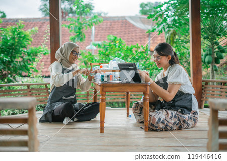 asian women making recycled plastic bottle craft together asian women making recycled plastic bottle craft together 119446416