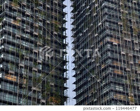 A very tall building that features numerous windows and many balconies 119446477