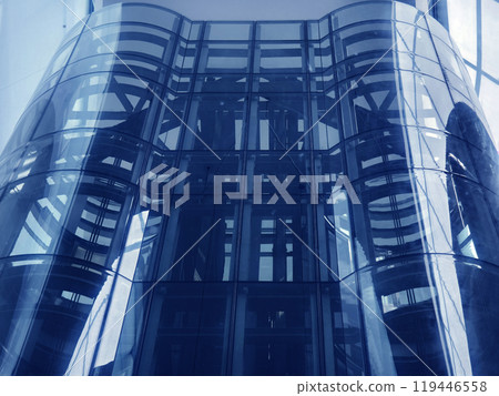 A modern tall building that features a significant amount of glass 119446558