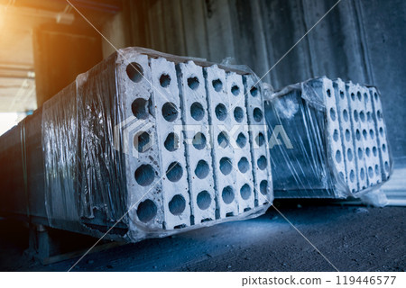 A large stack of concrete slabs on a construction site 119446577