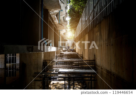 A construction site displaying a reinforced concrete foundation with steel rebar A construction site displaying a reinforced concrete foundation with steel rebar 119446654