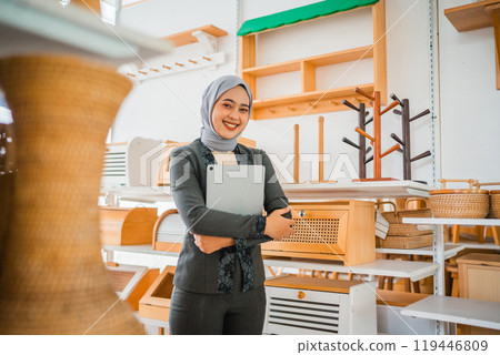 beautiful Asian businesswoman in hijab business owner smiling at a craft shop beautiful Asian businesswoman in hijab business owner smiling at a craft shop 119446809