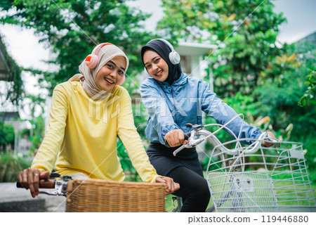 Joyful Friends happily Enjoying a Beautiful Day Outdoors while Riding Bicycles 119446880