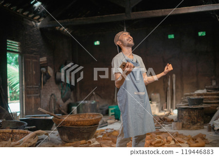 An Artisan Baker Joyfully Celebrates in a Rustic Kitchen Full of Flour 119446883