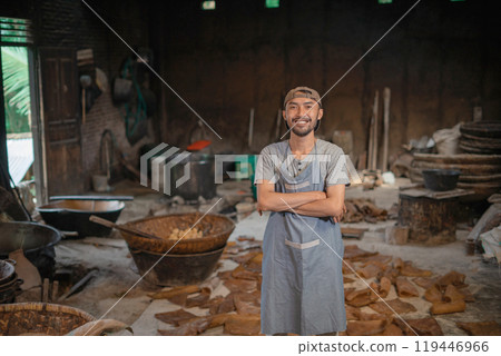 Skilled Artisan in a Rustic Workshop Surrounded by Tools and Materials 119446966