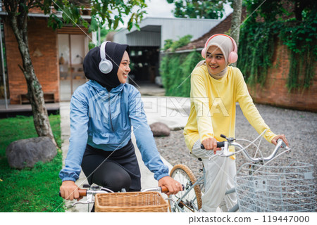 Friends biking on a sunny day, wearing headphones, and making great memories 119447000