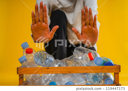 cropped view prohibit hand gesture and plastic bottle in wooden box storage cropped view prohibit hand gesture and plastic bottle in wooden box storage 119447173