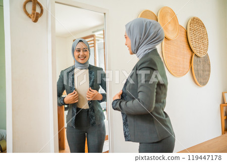 A Confident Woman Dressed in an Elegant Outfit Getting Ready for a Special Event 119447178