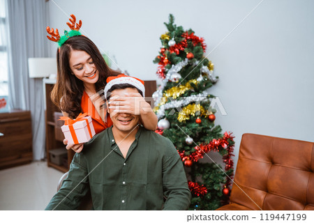 A Surprise Gift Unveiling Happening During the Christmas Celebration Festivities A Surprise Gift Unveiling Happening During the Christmas Celebration Festivities 119447199