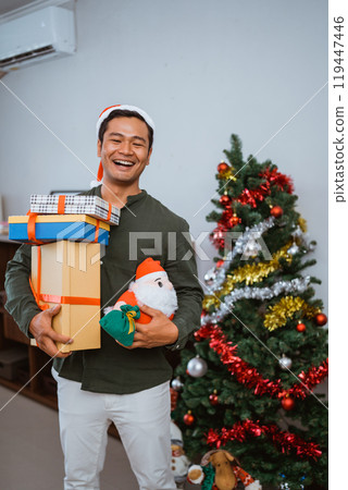 A Joyful Celebration Filled with Gifts Next to a Beautiful Festive Christmas Tree 119447446