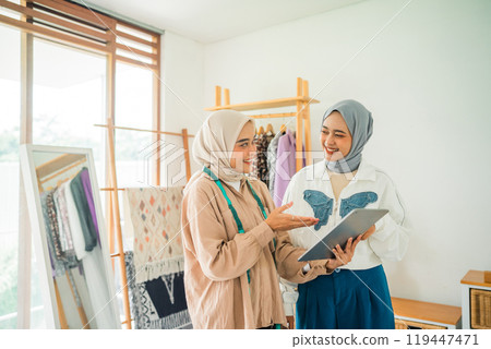 An Engaging and Creative Discussion Between Two Women Inside a Fashion Studio An Engaging and Creative Discussion Between Two Women Inside a Fashion Studio 119447471
