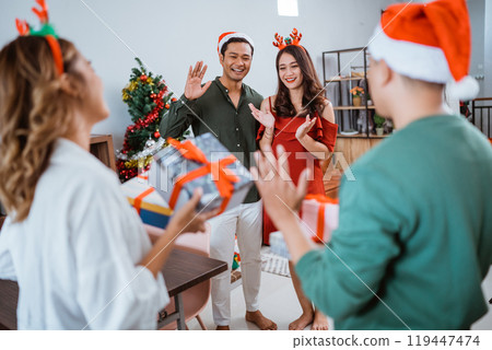 Experience a Joyful Holiday Celebration surrounded by Friends and Festive Gifts Experience a Joyful Holiday Celebration surrounded by Friends and Festive Gifts 119447474