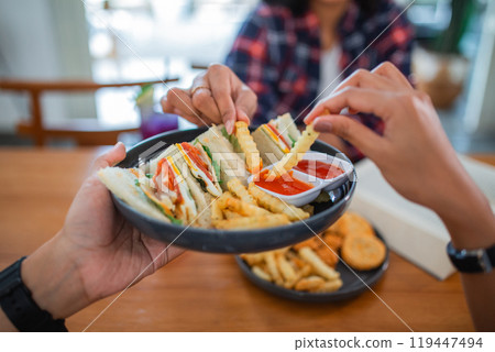 sandwiches and fries on a plate served with ketchup sandwiches and fries on a plate served with ketchup 119447494